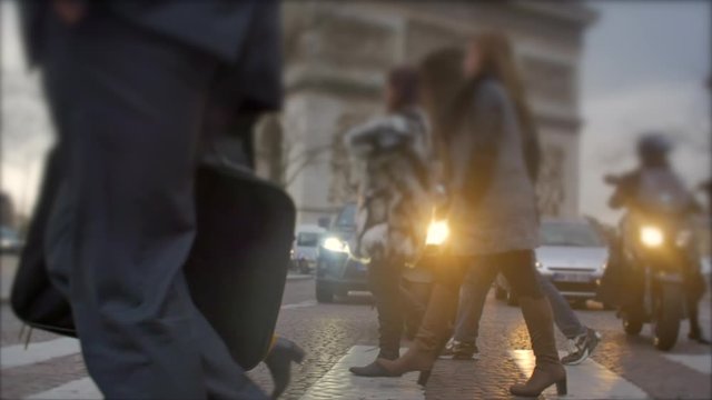 Young business man walks by the Eiffel tower, suit and briefcase, slow motion