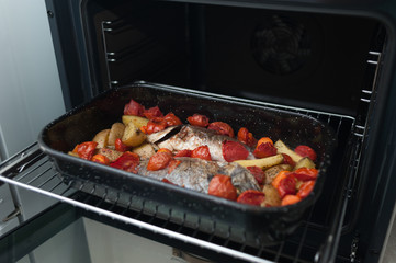 Fresh Baked fish with vegetables and potatoes in pan