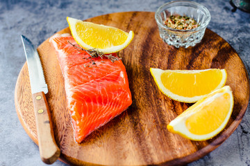 Salted smoked salmon with rosemary on a wooden board. Healthy food, diet concept