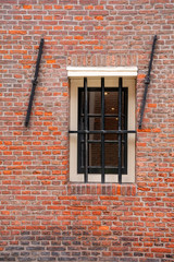 Window with lattice. Orange brick wall