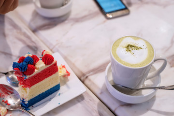One piece cheesecake on a plate With hot green tea in a glass