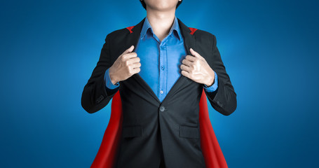 Super business man wears black suits and red robes with super heroes coaching concept on shine blue background and smart. Investors receive a lot of profits with business success.