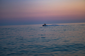 Sunny sunset over the summer warm and clear sea