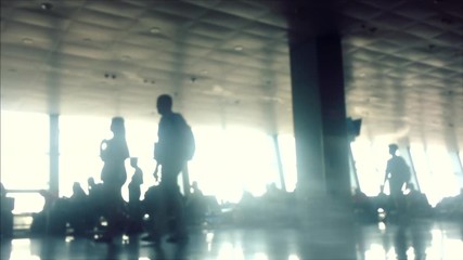 Defocusing. Busy Airport Terminal. Traveler at airport, Side view of multiracial people standing in queue to check in in airport hall. Departure board displaying flight information
