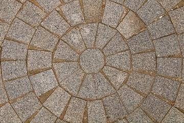 The texture of the stones. Paved stone on the sidewalk in the center of the city laid out in a circle.