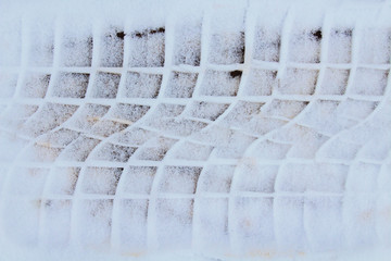 Car track in the snow. Close-up. Top view. Background. Texture.