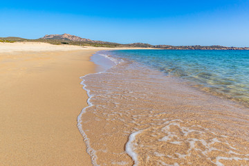 Secluded beach with golden sand and blue sea water, Corsica, France