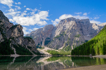 mountains that are reflected on Lake Braies in the midst of nature