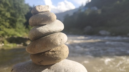 Stack Of stones on river in Mountains 