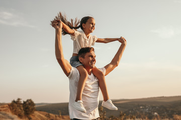 Happy father and daughter having fun in nature