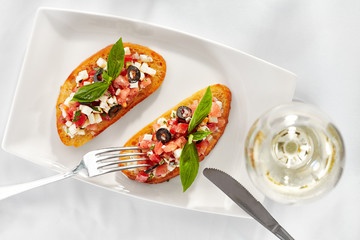 Italian Appetizer Bruschetta with Tomatoes, Cheese and Basil