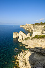 Stunning sunset that illuminates the beautiful village of Bonifacio built on a limestone cliff. Bonifacio is a commune at the southern tip of the island of Corsica, France.