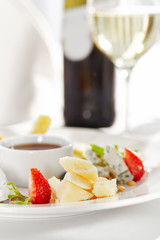 Gourmet, restaurant, delicious dinner food - close up of cheese plate with honey dip and fresh berries