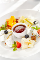 Gourmet, restaurant, delicious dinner food - close up of cheese plate with honey dip and fresh berries