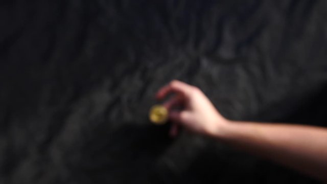 Slow Motion Of A Male Hand Flipping A Bitcoin With A Rustic Background 