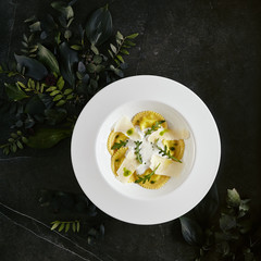 White Restaurant Plate of Ravioli 4 Cheeses with Cheese Espoume Top View