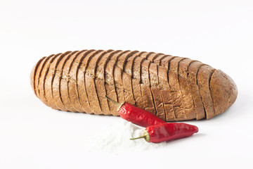 Rye bread with red chili peppers and salt on a white background isolated.