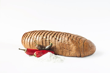 Rye bread with red chili peppers and salt on a white background isolated.