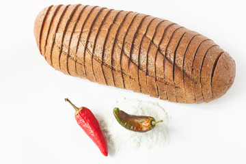 Rye bread with red chili peppers and salt on a white background isolated.
