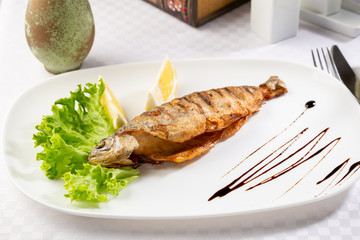 Roasted river fish on plate