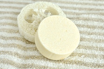Fototapeta na wymiar Close up view of solid shampoo bar made from natural ingredients on linen towel, no plastic, zero waste product