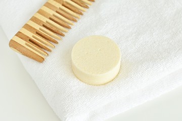 Solid shampoo bar on white towel. handmade, zero waste, plastic free product