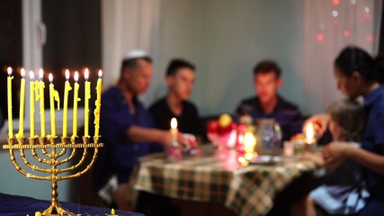 Happy Jewish Family Celebrates Hanukkah. Festival of Lights. Israel people. The Hanukkah menorah