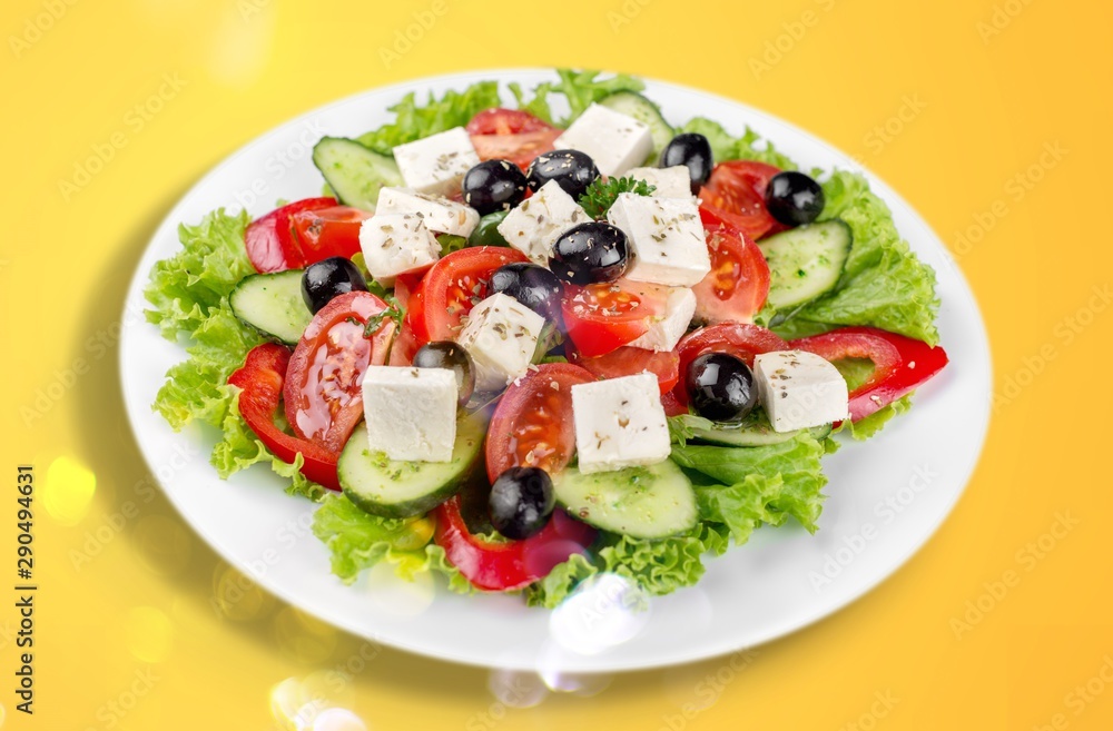 Poster Greek salad with fresh vegetables on background