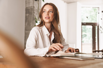 Business woman sit indoors in office using laptop computer
