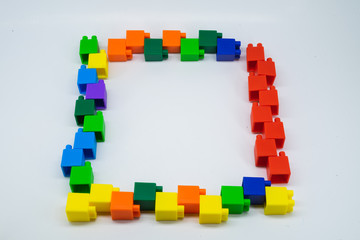 Plastic building blocks frame isolated on white background