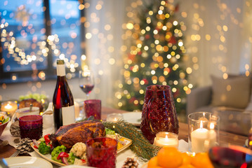 christmas dinner and eating concept - food and drinks on table at home