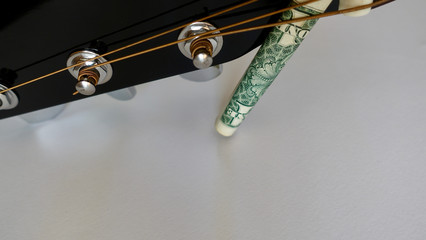 guitar headstock with tuning pegs  and dollar . color background . closeup