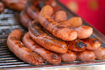 German streetfood, many BBQ grilled sausages ready to eat
