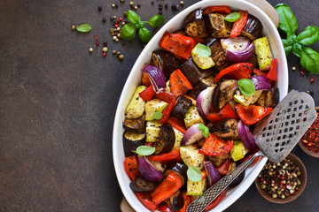 Fototapeta na wymiar Oven Roasted Vegetables: zucchini, eggplant, tomatoes, paprika. Ratatouille is a rustic dish of vegetables.