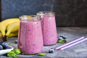 Purple smoothies with blueberries on the kitchen table. Detox menu.