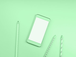 Mobile phone screen on green mint background with pencils. Minimal flat lay on color of 2020....