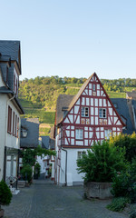 Fototapeta na wymiar Street in old German town with traditional medieval timber framing houses