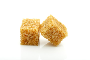 two cubes of brown cane sugar isolated on white background