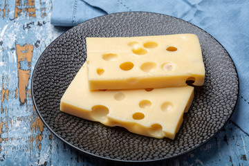 Two blocks of French emmental semi-hard cheese