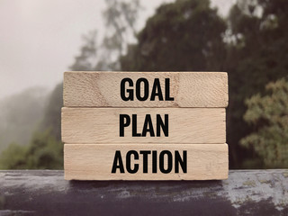 Motivational and inspirational words - Goal, Plan, Action written on wooden blocks.