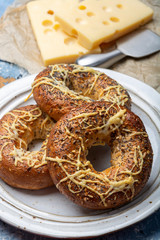 Tasty baked bagels with melted french emmental cheese