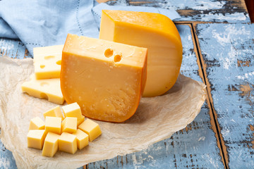 Famous hard cheeses, Dutch Gouda and French Emmentaler in pieces and blocks