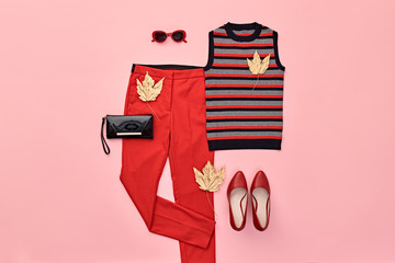 Autumn Arrives. Fashion Lady Clothes fall Outfit. Trendy top, red trousers. Stylish Handbag, Gold...