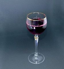 glass of red wine on black background