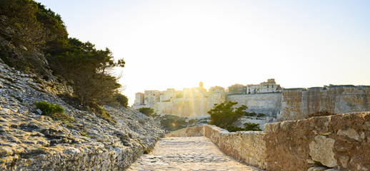 Stunning sunset that illuminates a pathway that leads to the beautiful village of Bonifacio...