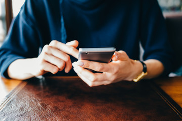 Close-up of a woman holding a mobile phone