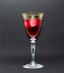 glass of red wine on black background