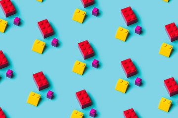 Top view of plastic blocks background. Flat lay image of toy background made with pink building blocks from child constructor.