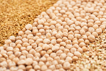 close up view of raw chickpea between assorted grains