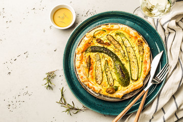 Pizza with baby zucchini on blue plate - vegetarian meal
